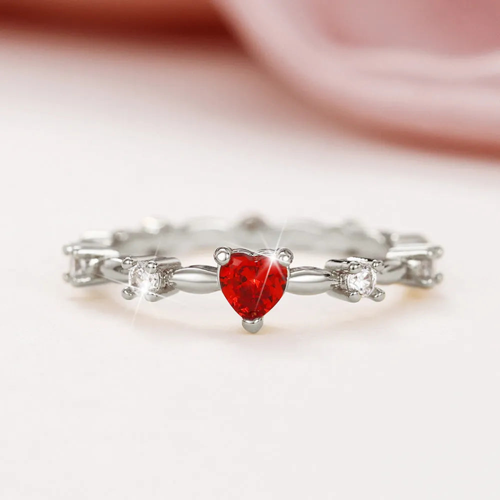 Gold and silver electroplated peach heart ring with zircon stones on a copper base.