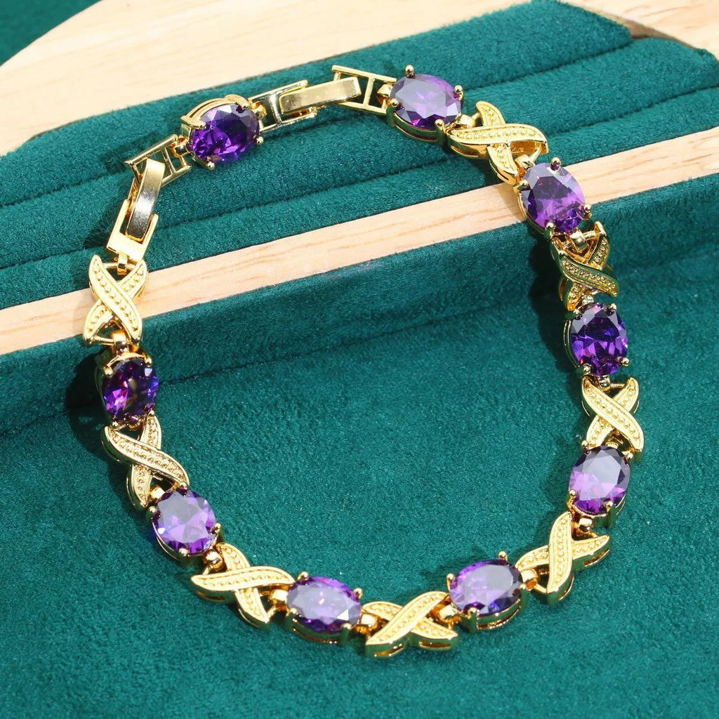 18k gold plated four-piece jewellery set with synthetic cubic zirconia stones in Raytheon cut, showing necklace, earrings, ring, and bracelet