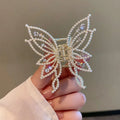 Butterfly hair barrette measuring 6.7cm x 6.2cm with electroplated alloy construction