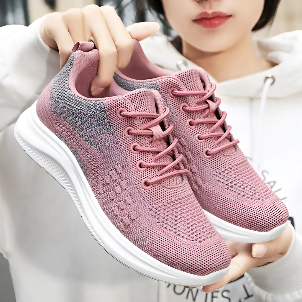 Women's black lightweight mesh sneakers with lace-up front and soft PVC sole on a white background.