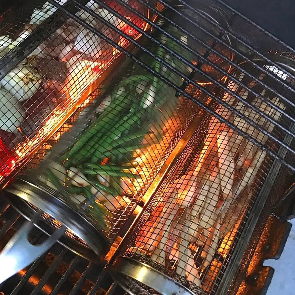 Stainless steel cylindrical rolling grill basket for BBQ with wire mesh, shown with vegetables inside.