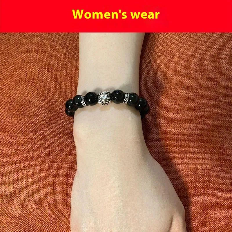 Natural obsidian and 999 silver unisex bracelet on a wrist, showing 10mm or 12mm bead size options.