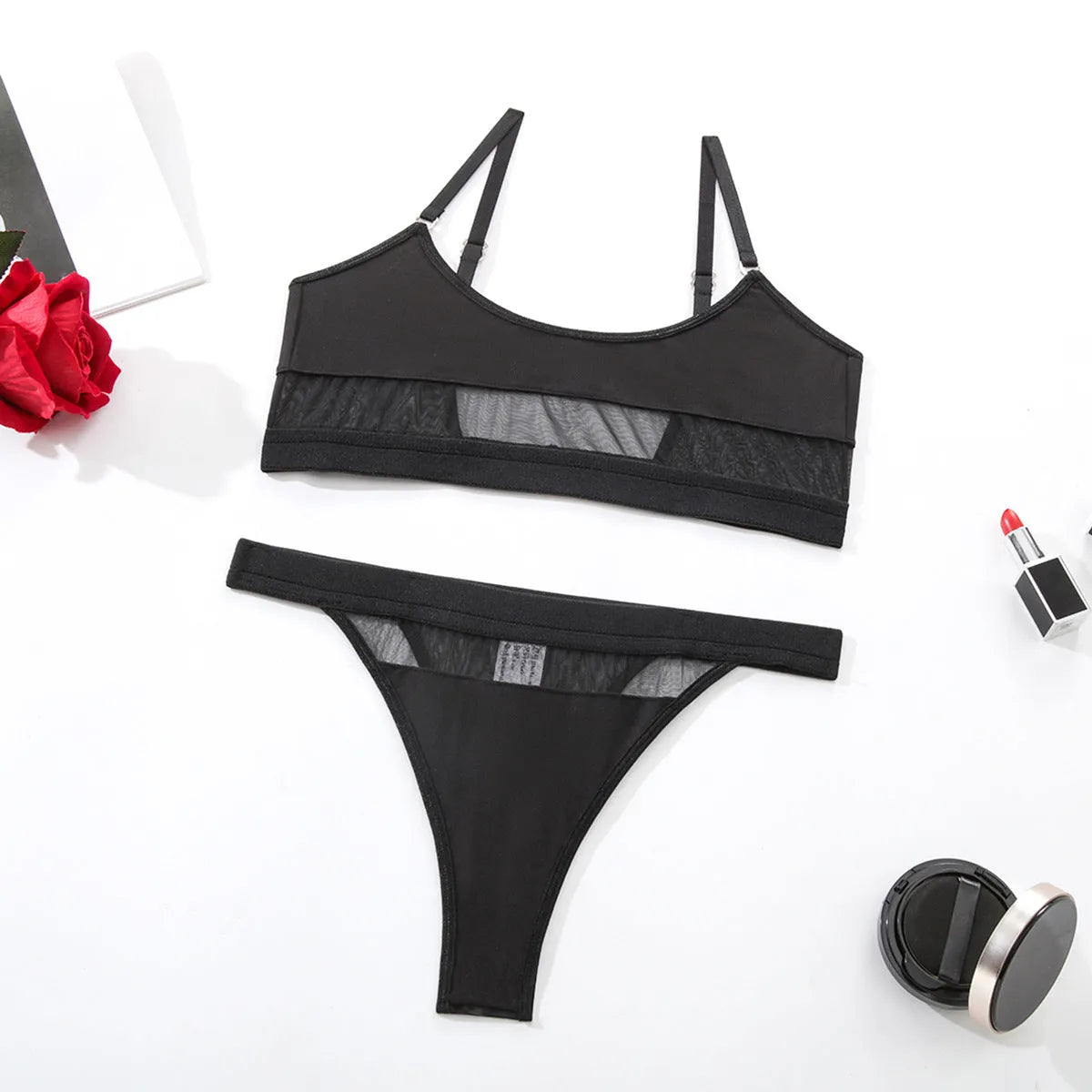 Women's black full cup bra and panty set with adjustable straps on a white background.
