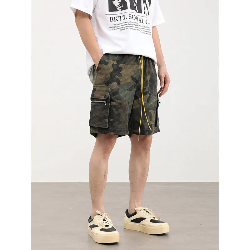 Men's camouflage multi-pocket work shorts showing cropped length and pocket details