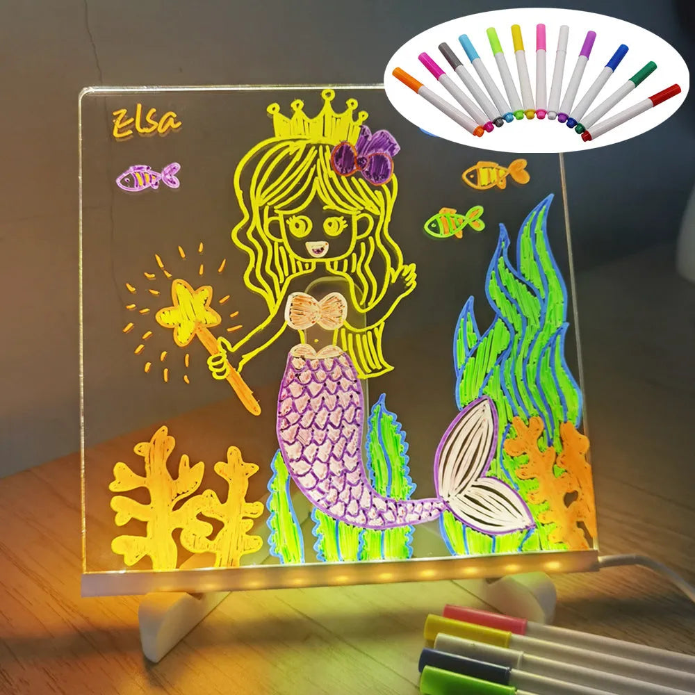Acrylic DIY LED message board night light on a desk with handwritten drawing glowing softly.
