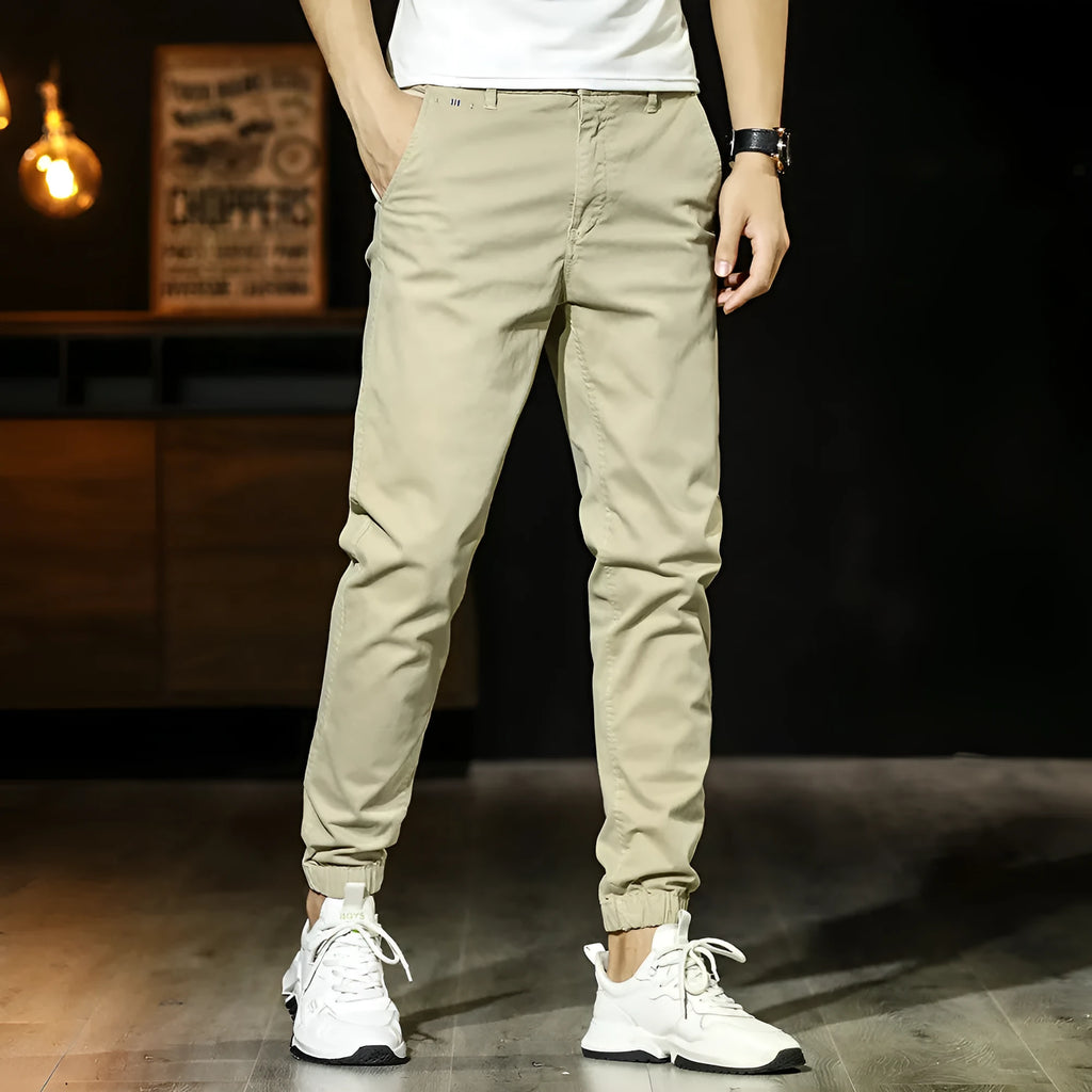 Men's cotton tapered casual trousers with ankle-tied hem, mid waist and zipper fly in khaki, black, coffee army or medium grey.