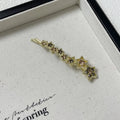 Gold metal hair barrette with a star charm and side clip for bangs.