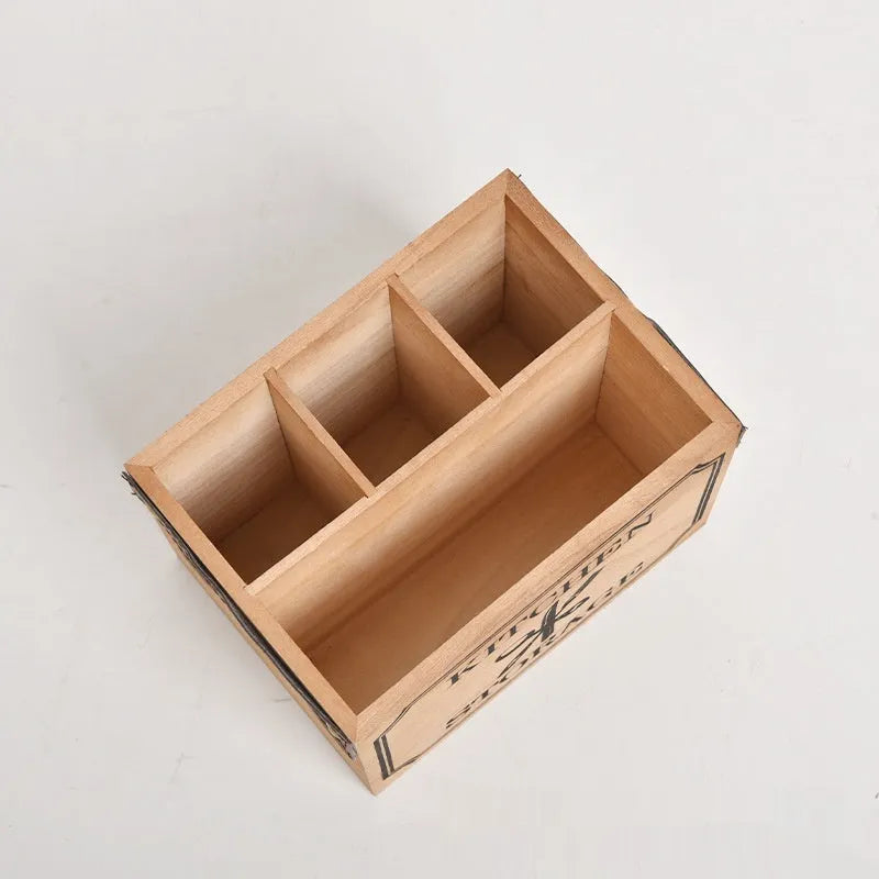 Wooden kitchen storage box with internal grid divider for organising knives, forks, and chopsticks.