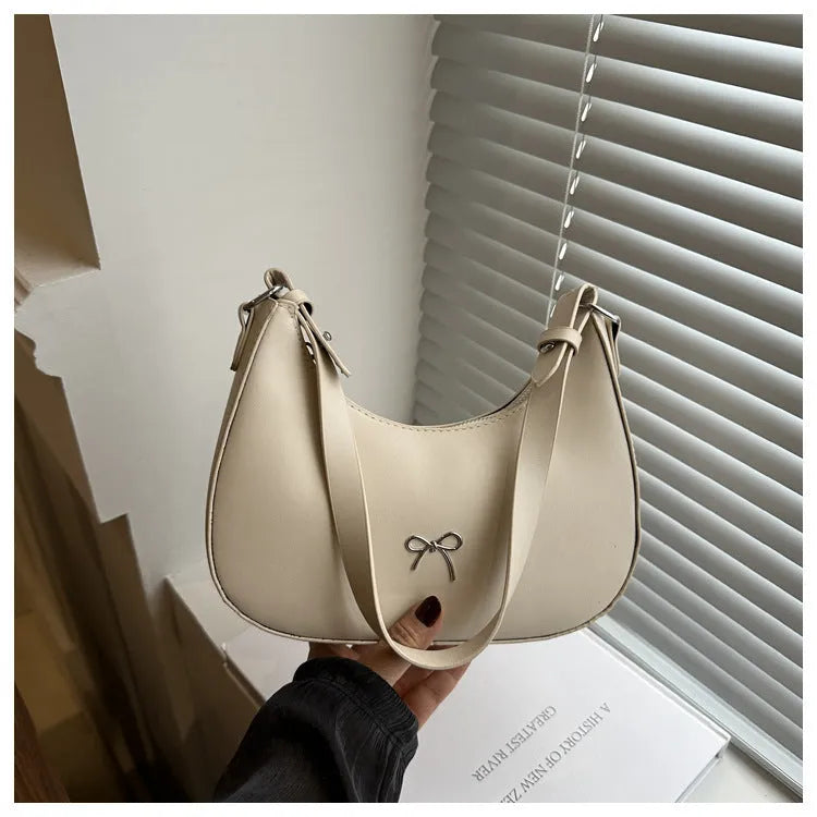 Women's PU dumpling-shaped underarm baguette handbag in six colours with a single strap.