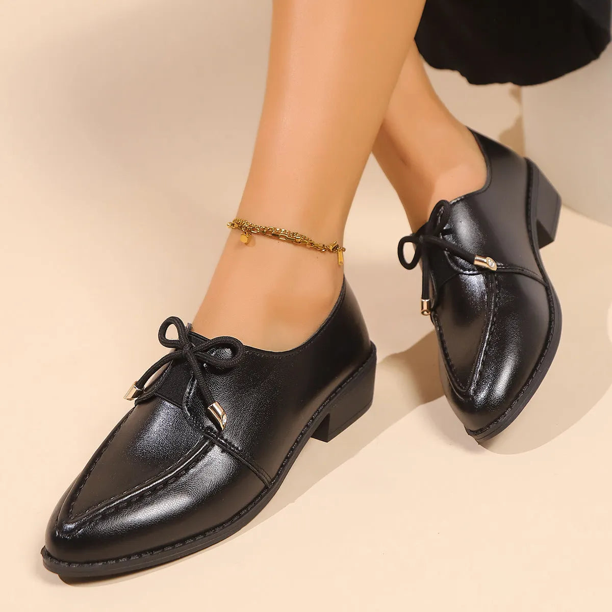 Women's British-style simple leather shoes with bow detailing, PU upper, and rubber sole in available sizes.