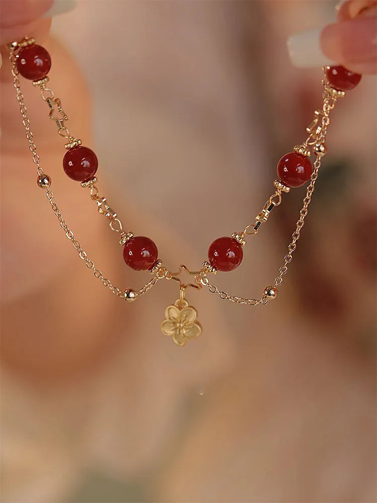 Women's red agate double layer bracelet with floral motifs and adjustable sliding knot closure
