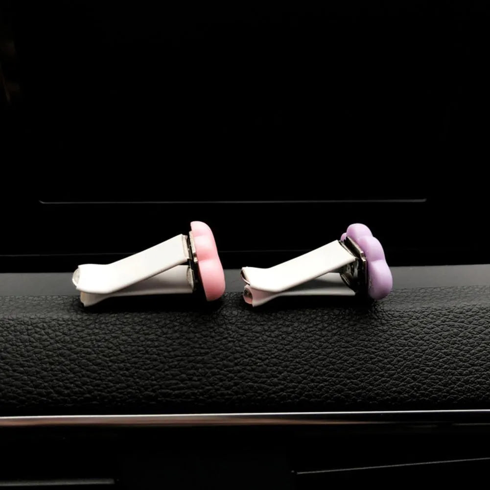 Resin cartoon car fragrance clip in light green colour, dimensions 17mm by 27mm, on a car air vent