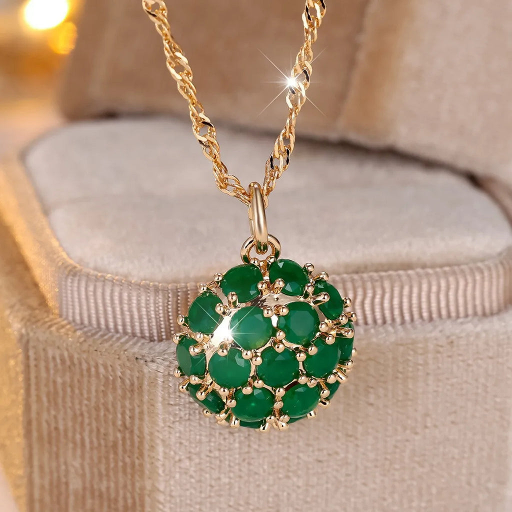 Champagne gold necklace with round emerald pendant and full diamond setting on an adjustable chain.