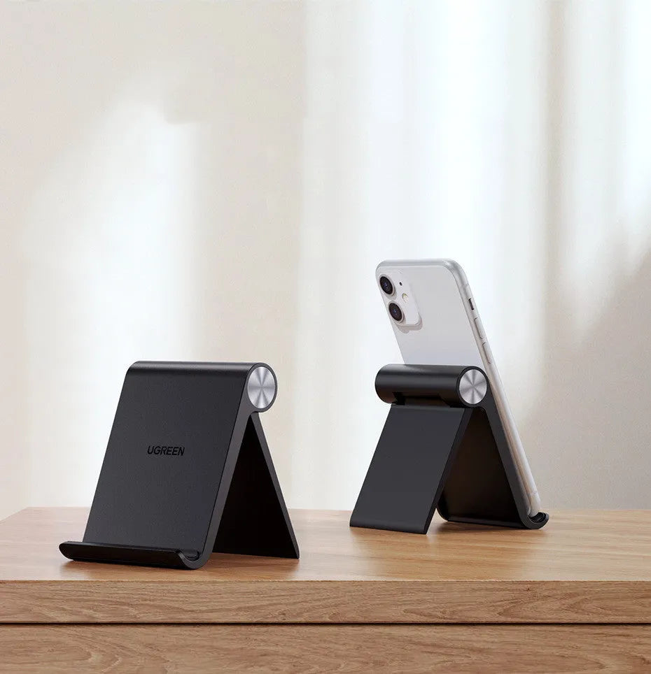 UGREEN LP106 portable phone holder in black, blue, or white, holding a smartphone at an adjustable angle.