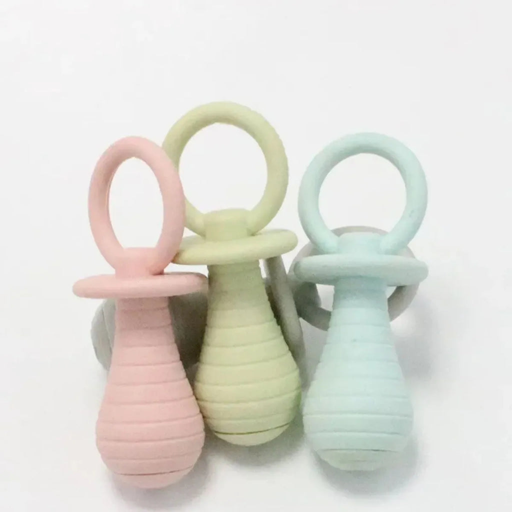 A green TPR rubber pet pacifier chew toy with a squeaker for puppies and kittens.