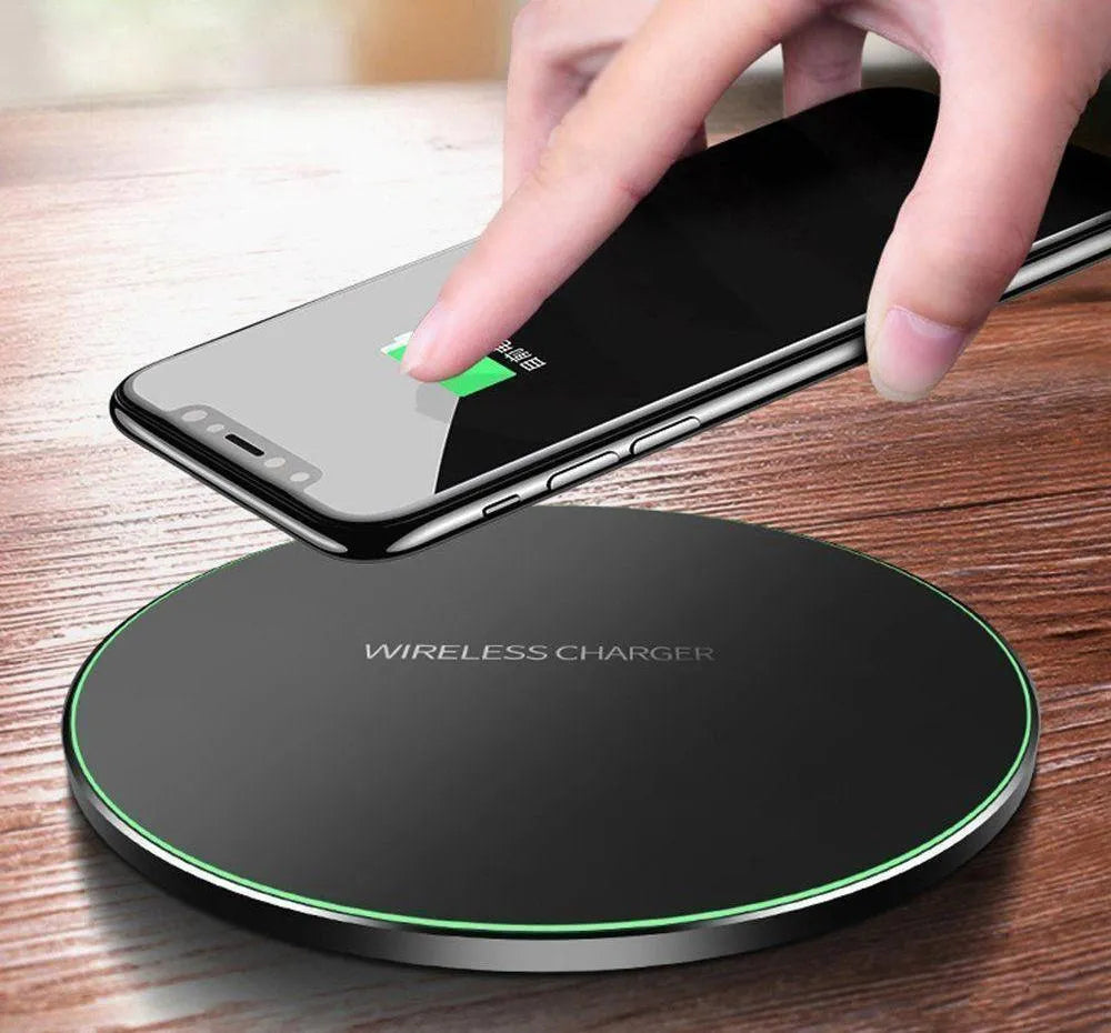 Ultra-thin black wireless charging pad measuring 98mm square with 6.5mm thickness on desk surface