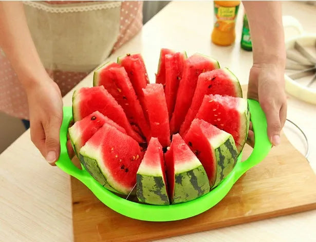 Green plastic and stainless steel melon slicer tool on a kitchen counter.