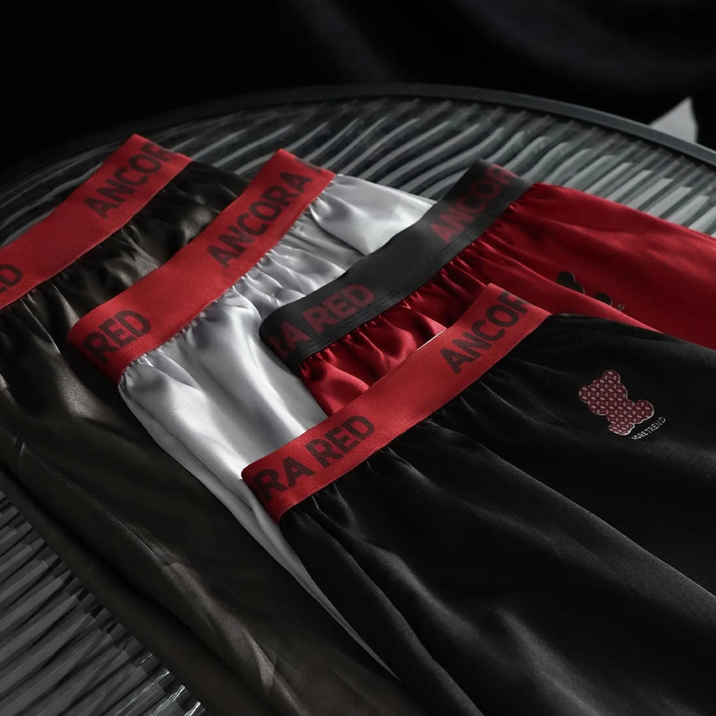 Solid colour men's boxer briefs with mid-waist design in black, red, blue, silver, purple, or brown