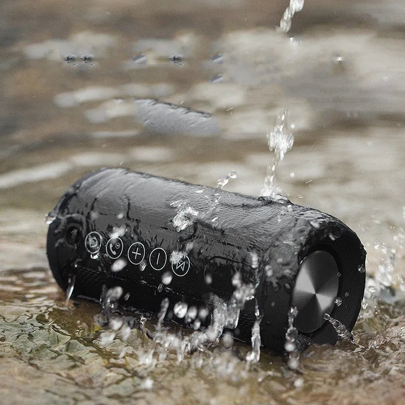 Outdoor waterproof Bluetooth speaker in black, camouflage, grey, or red colours with 20m range and 8-hour battery