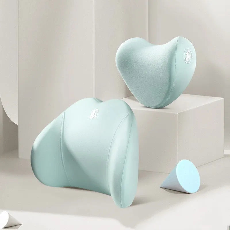 Heart-shaped black and grey car pillow set for headrest and lumbar support on a car seat.