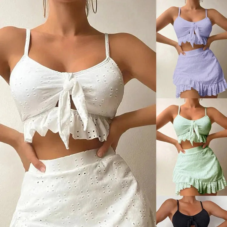 Women's solid colour split hip skirt bikini swimsuit three-piece set on a mannequin.