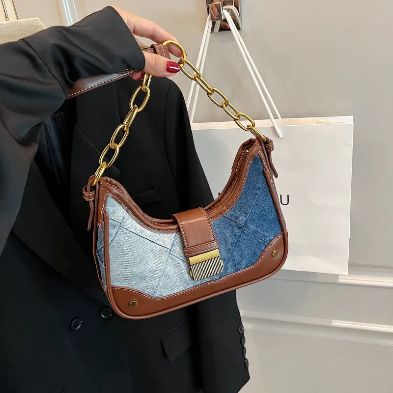 Brown denim women's bucket shoulder bag with diamond mesh detail, chain accents, and double adjustable straps