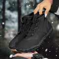 Outdoor snow boots in black with waterproof umbrella cloth, fleece lining, and non-slip rubber soles on a snowy background