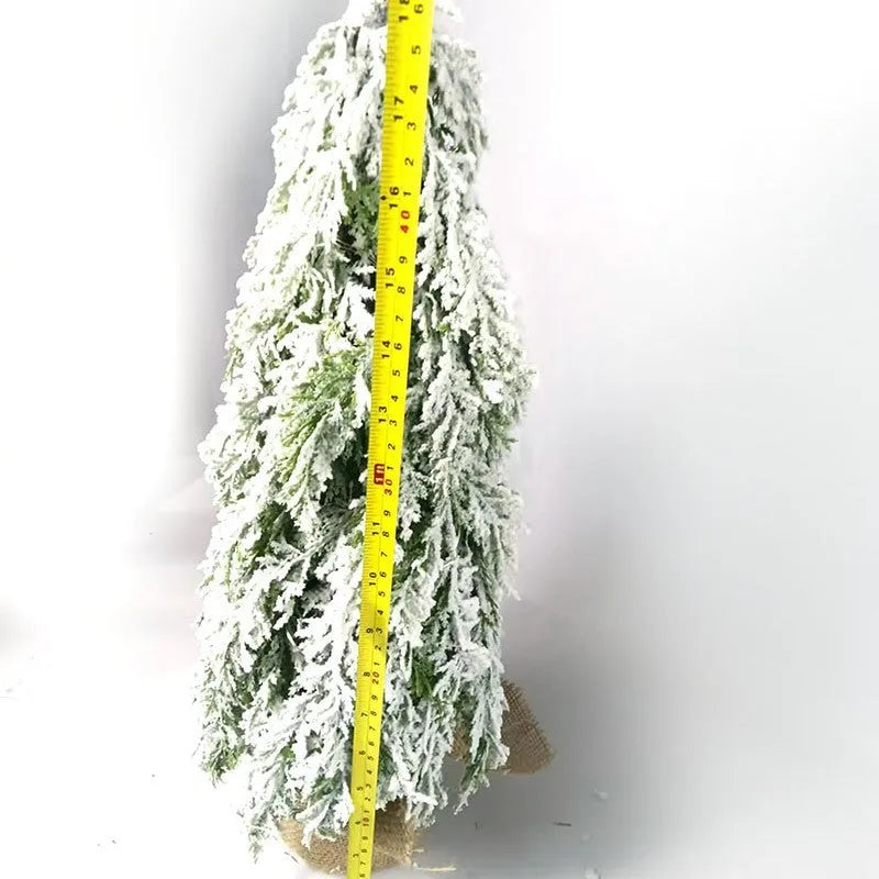 24-inch desktop Christmas tree with PE snow simulation and integrated lighting on wooden surface