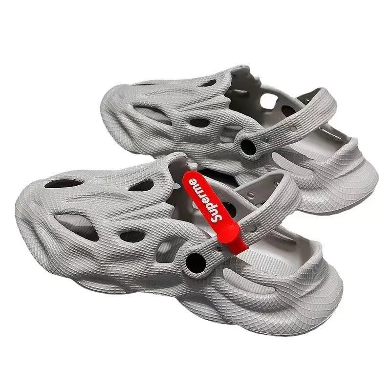 Grey closed toe EVA coconut slippers for beach wear on a sandy background