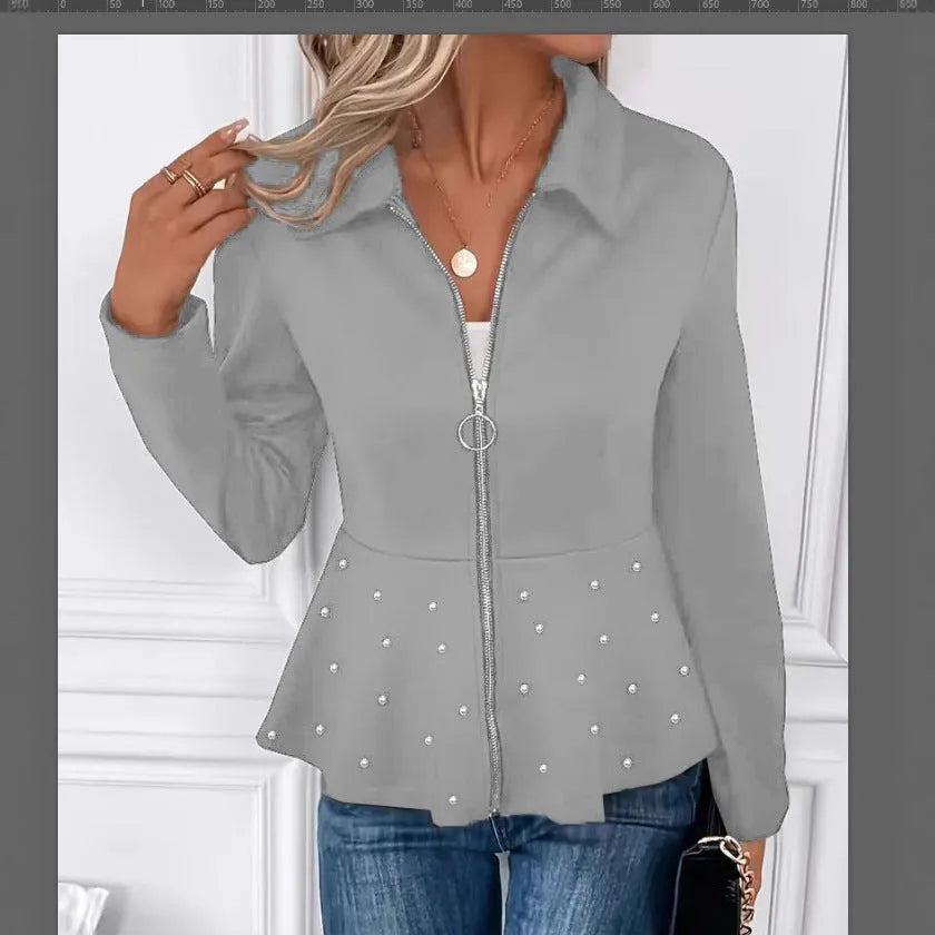 Women's loose-fit black coat with heavy-duty beaded zipper and ruffled hem, long sleeves.