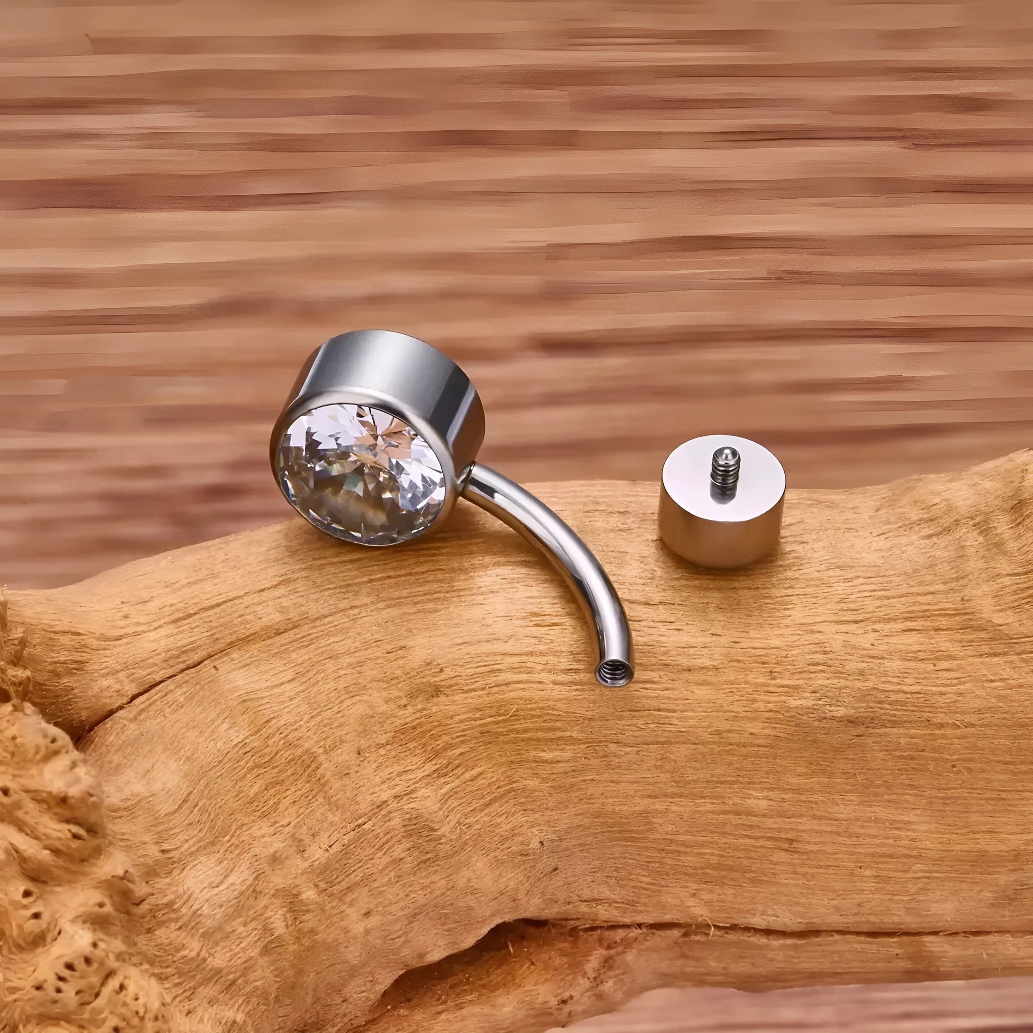 Titanium alloy double-headed navel stud with zircon accents in various colours and lengths.