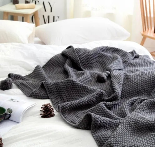 Nordic fringed knit ball blanket in beige colour showing 130×170cm dimensions and textured edge detail