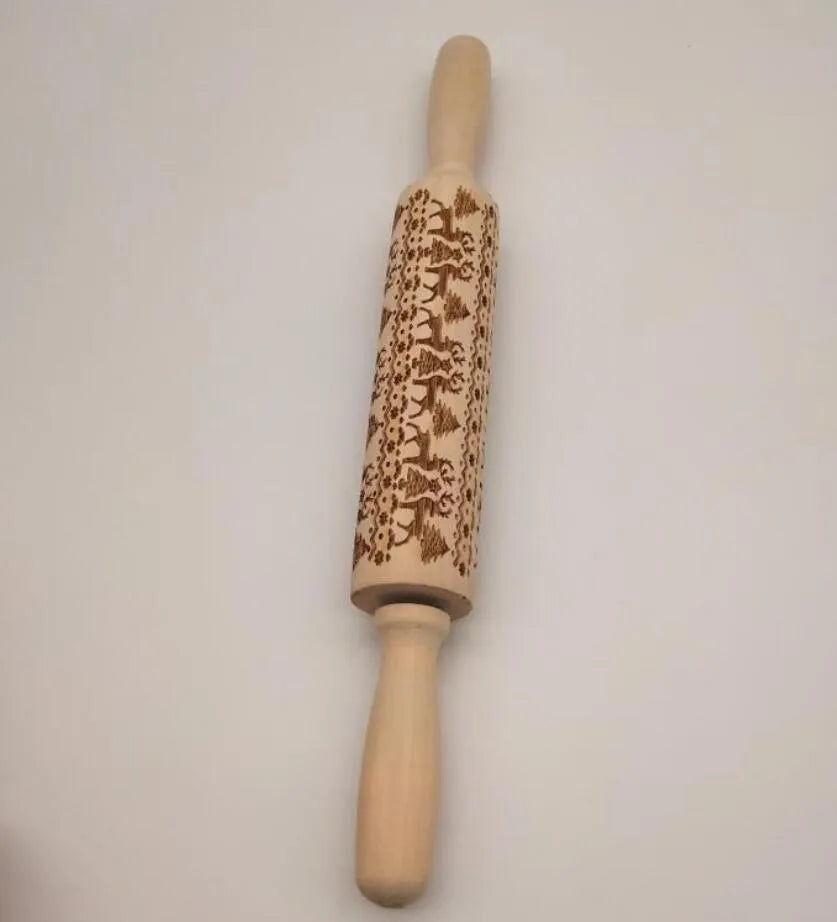 Solid wood rolling pin with embossed Christmas reindeer pattern on a 45cm long shaft.