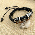 Braided leather bracelet with alloy cross studs, shown in black and brown colour options.