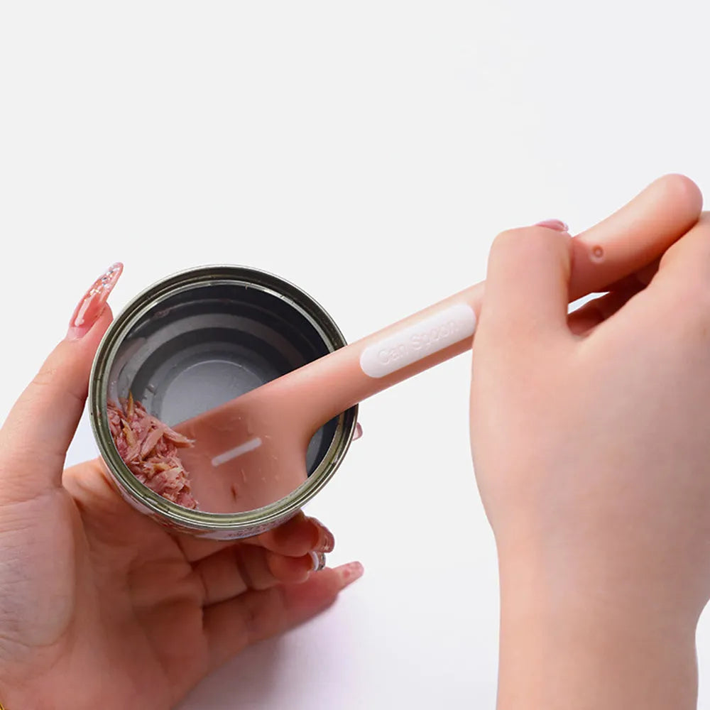 Green pet feeding spoon with 16cm handle scraping canned food from jar