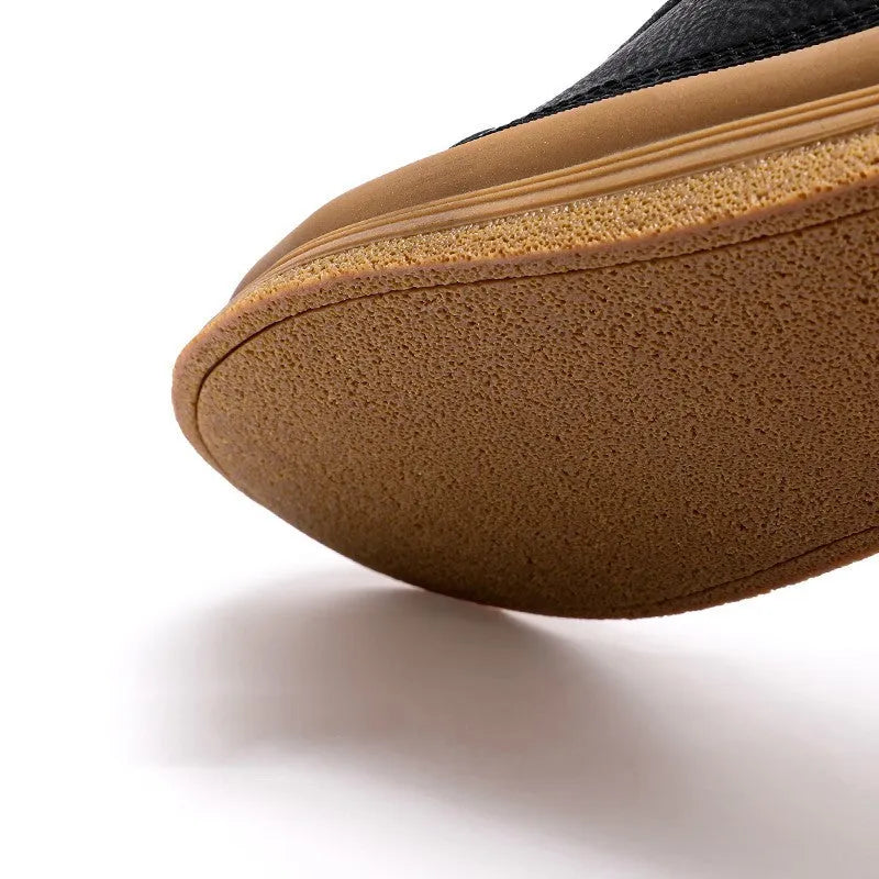 Men's black casual leather shoes with round toe, flat heel, and lanyard closure on neutral background