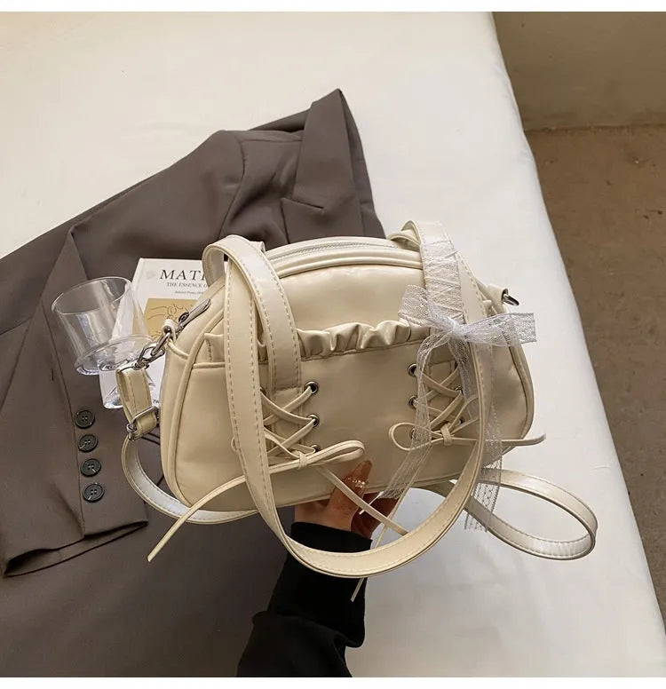 Women's bandage bow handbag in PU leather with mobile phone compartment and decorative sewing thread details