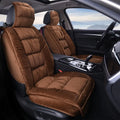 Short plush winter car seat cushion in grey on a car seat.