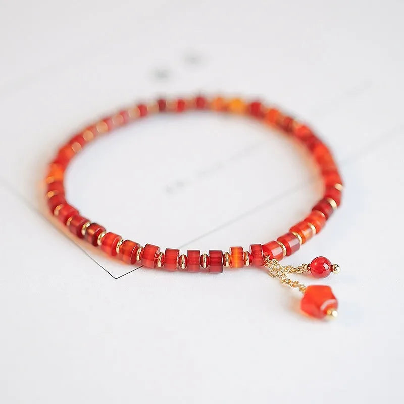 Hand-woven red agate bead bracelet with diamond pattern and lucky charm in ethnic style