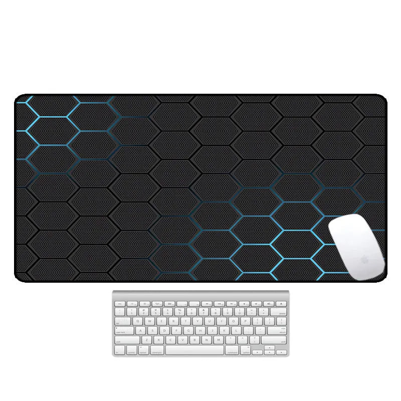 Large rectangular mouse pad with printed pattern lying flat on a wooden desk.