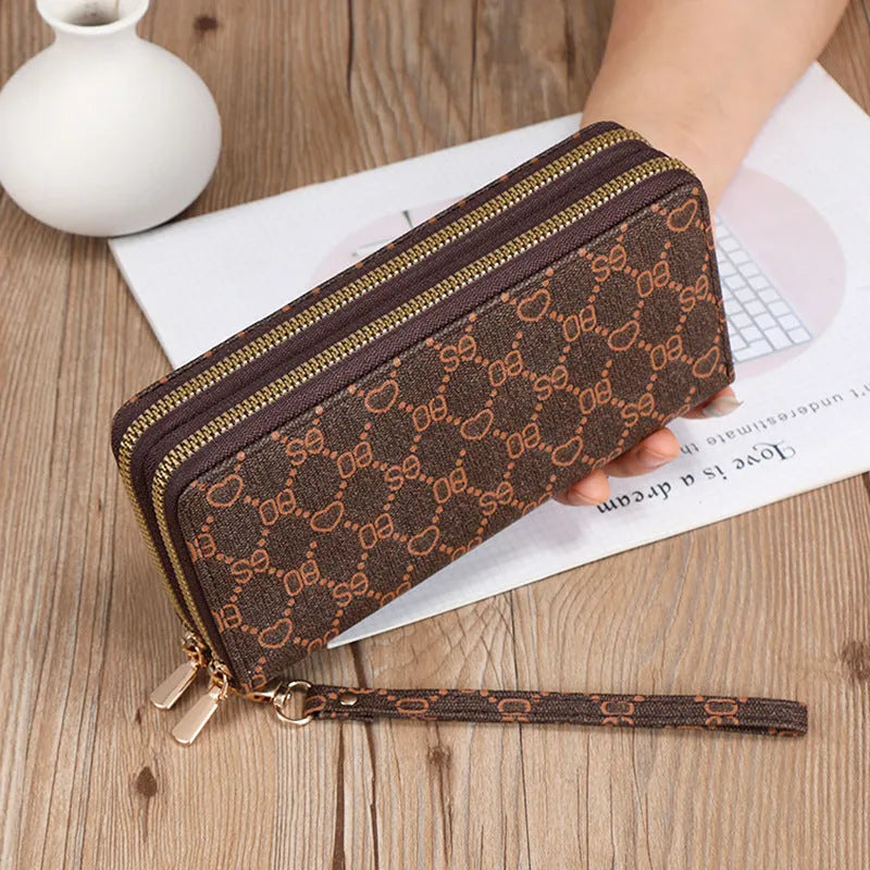 Retro style long wallet clutch in PU leather with a print design, shown in black colour.