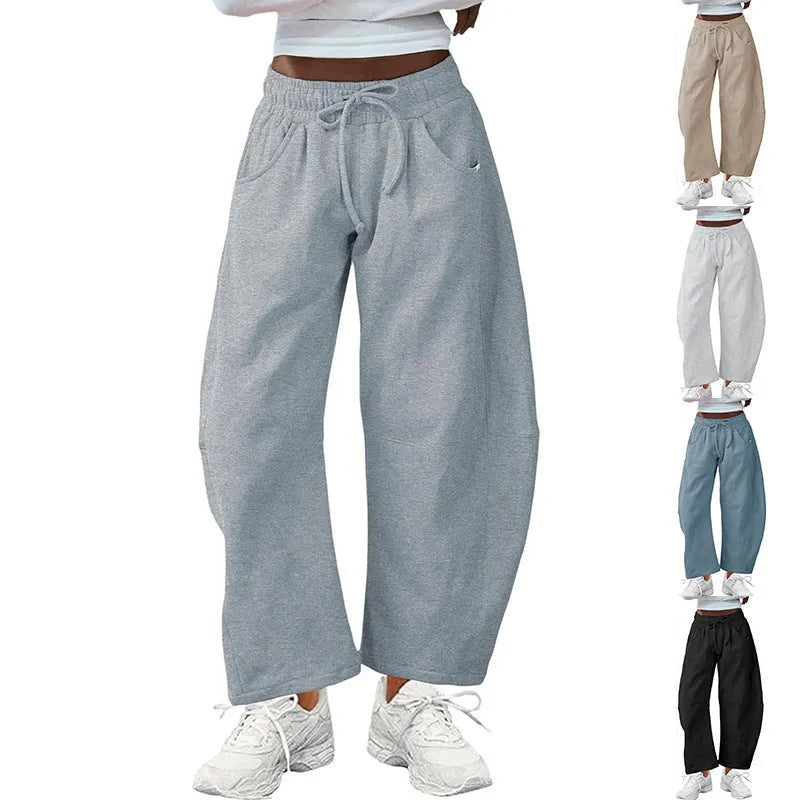 Loose sports cropped sweatpants in hot light grey with elastic waist and drawstring, showing collage/stitching craft details