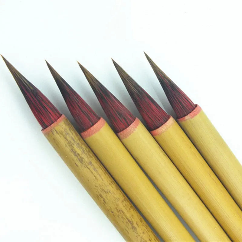 Small red-haired writing brush with a 23cm long handle on a flat surface.