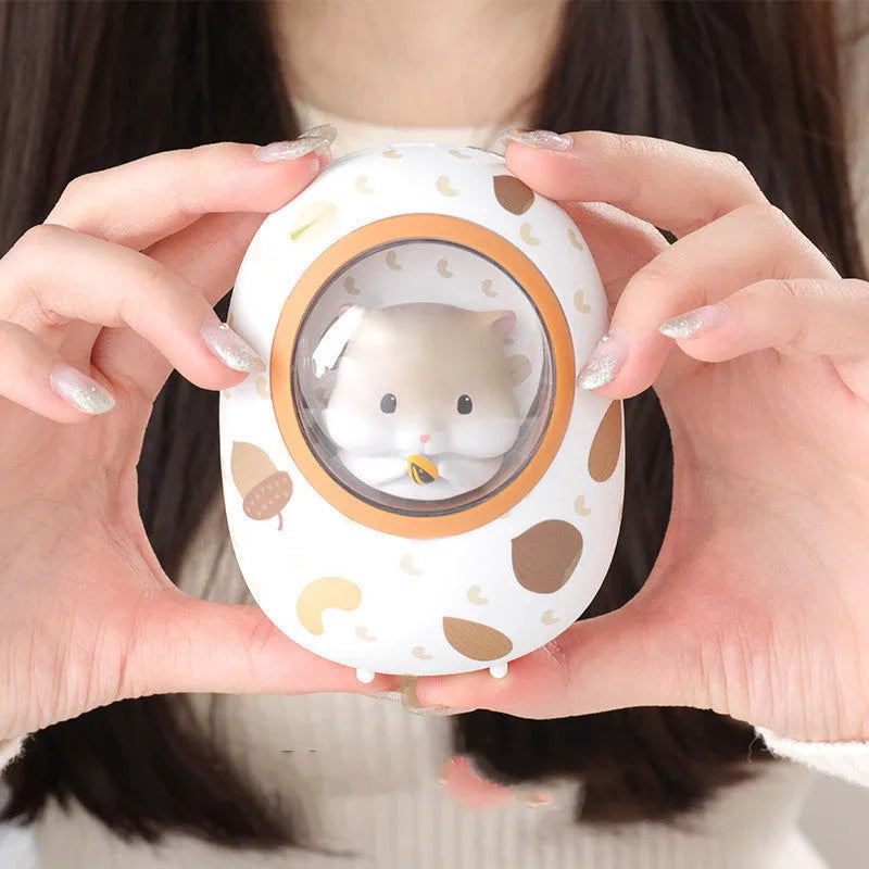 White hamster hand warmer power bank with space capsule design showing heating controls and USB ports