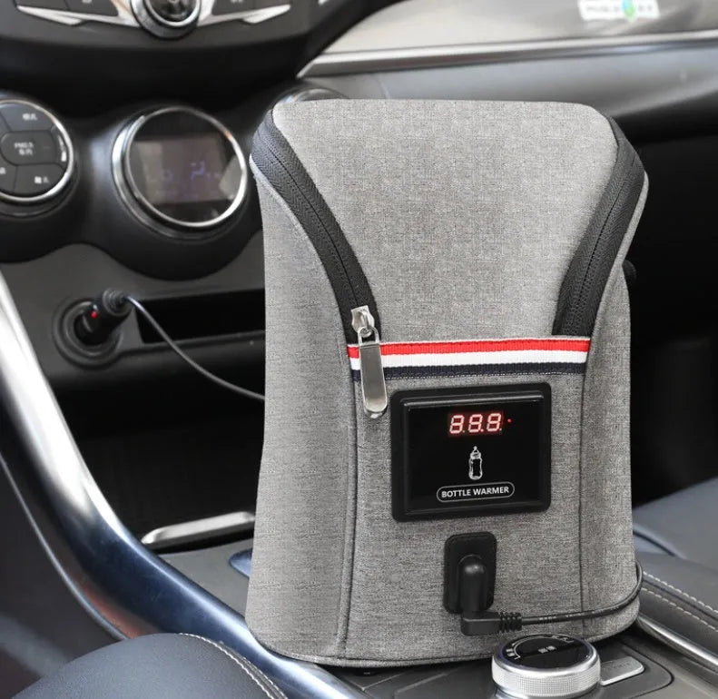 Grey portable baby bottle warmer with electronic display, car charger, and buckle for hanging on prams