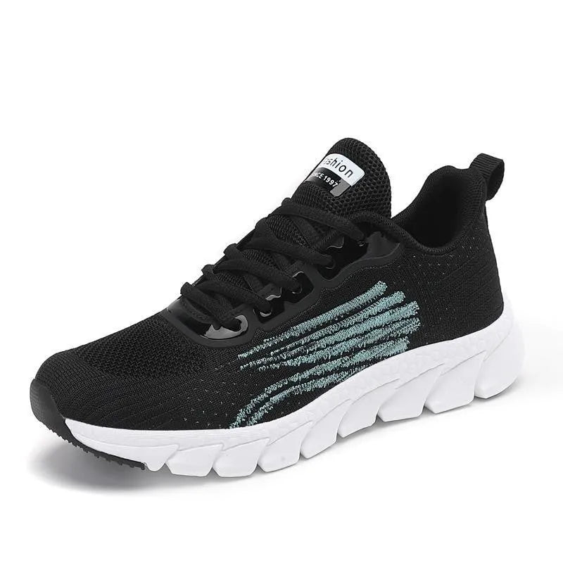 Women's low-cut black and white casual running sneakers with cross-strap detail and a lightweight MD sole.