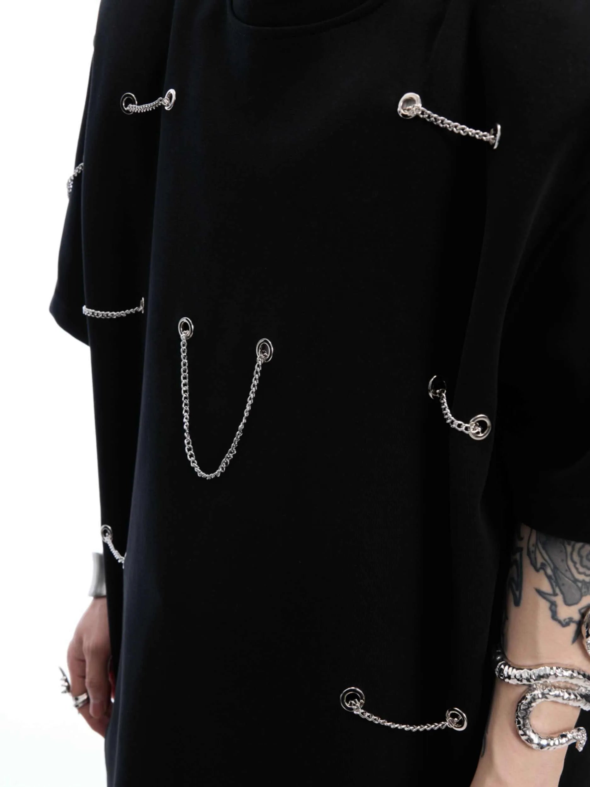 Black men's T-shirt with metal chain detail on padded shoulders, short sleeves, and round neck.