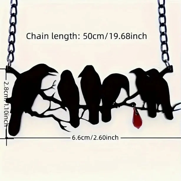 Black crow pendant necklace with cross chain on dark background