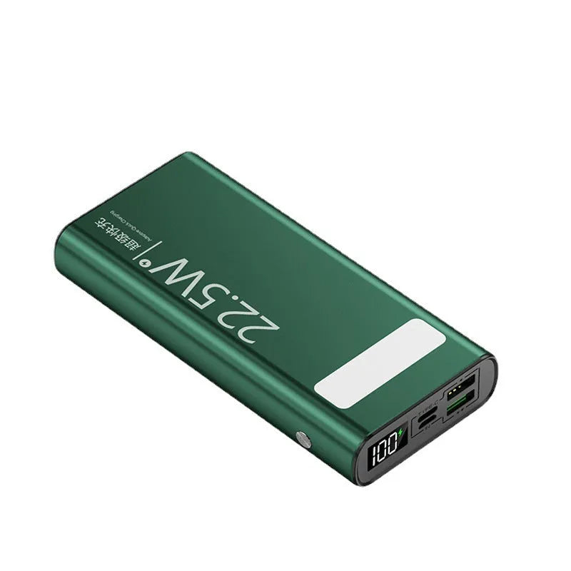Black alloy power bank showing LCD display and USB ports on a grey background.