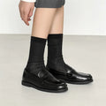 Black men's leather slip-on derby shoes on a white background